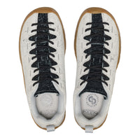 Pair of white sneakers with black laces and brown soles on a white background