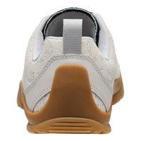White sneaker with brown sole on a white background