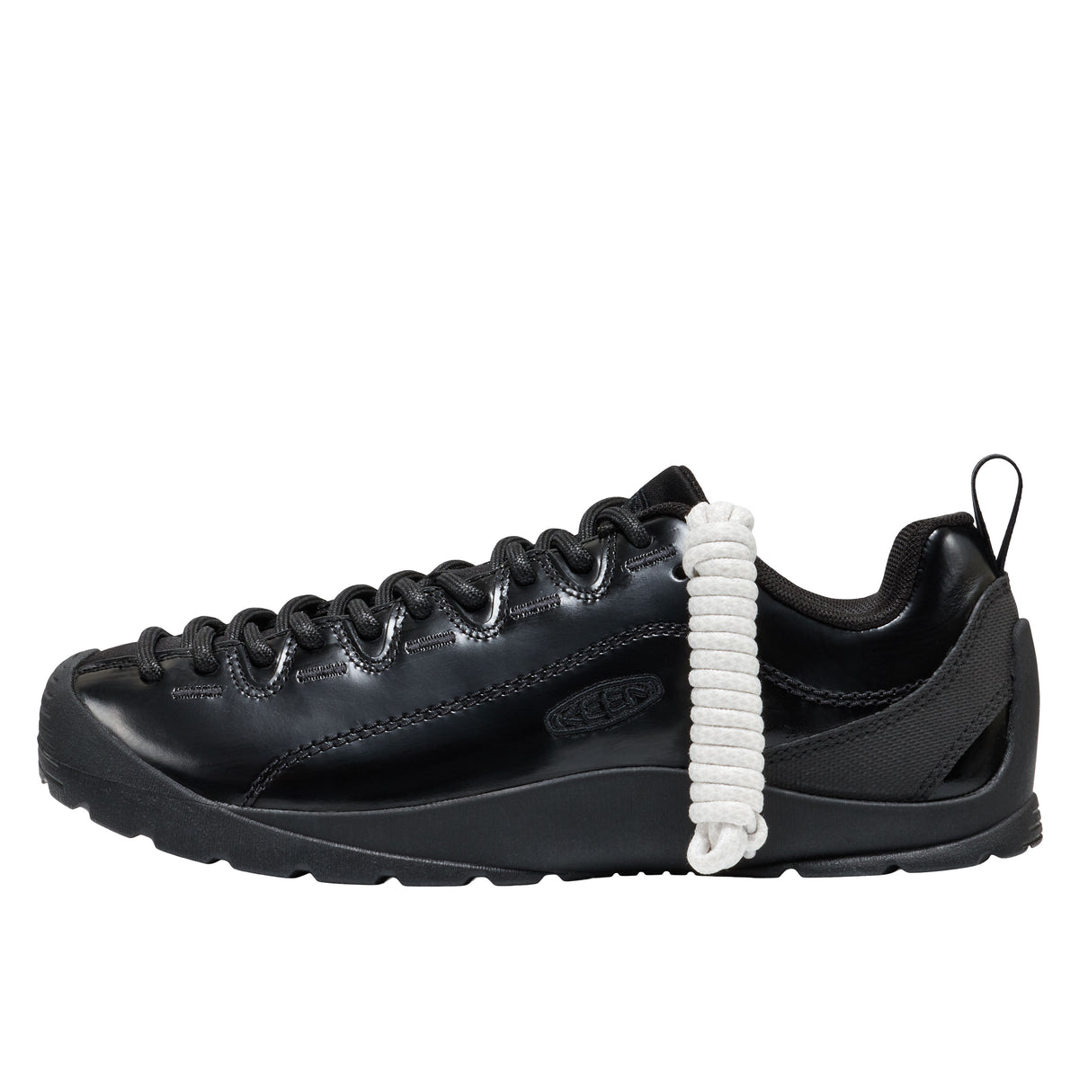 Black sneaker with a white shoelace on a white background