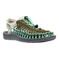 Sandal with brown and green woven design on a white background