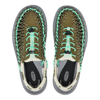 Pair of KEEN sandals with green laces on a white background