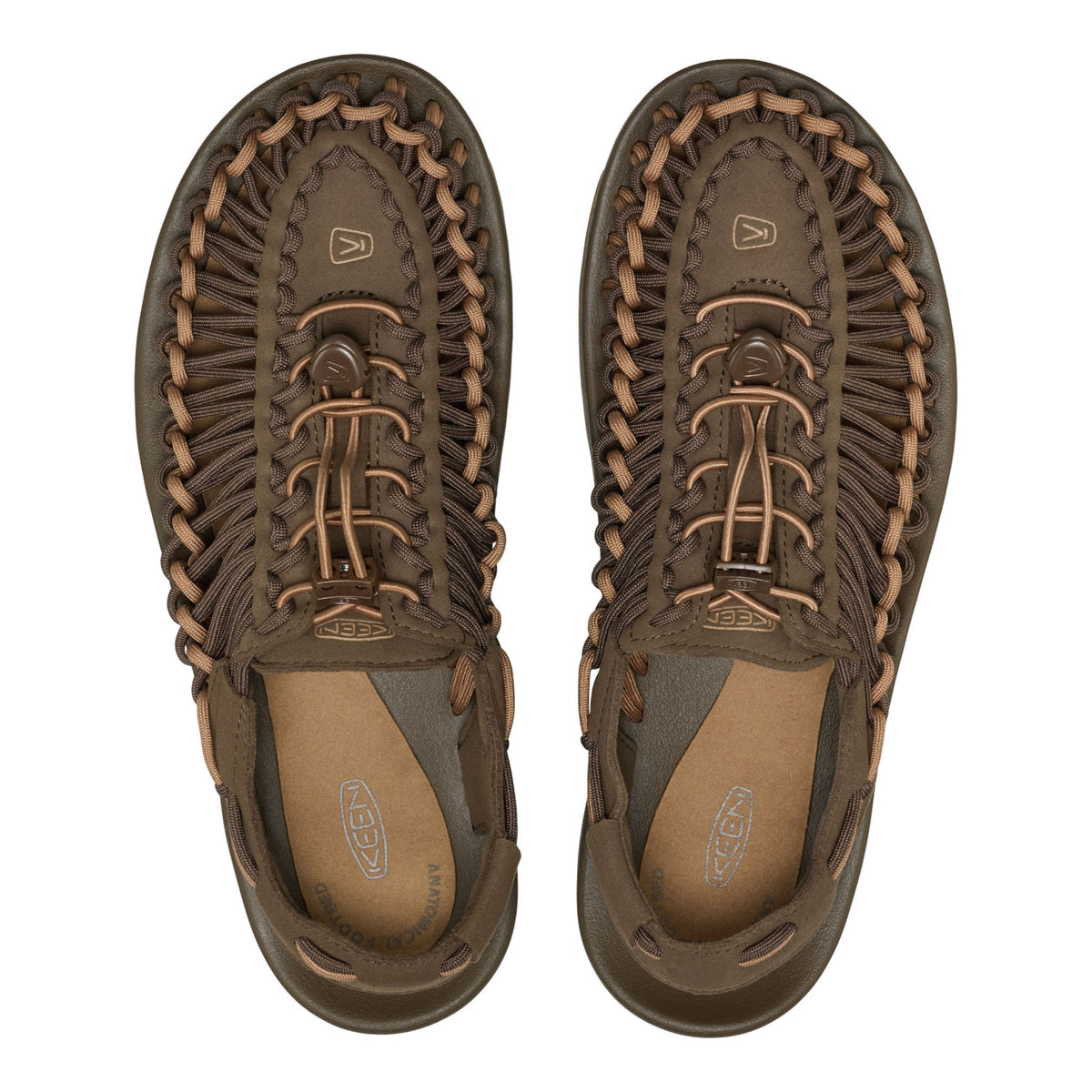Pair of brown sandals with braided details on a white background