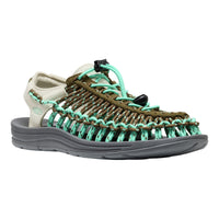 Sandal with green and brown straps on a white background