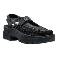 Black sandal with a thick sole on a white background