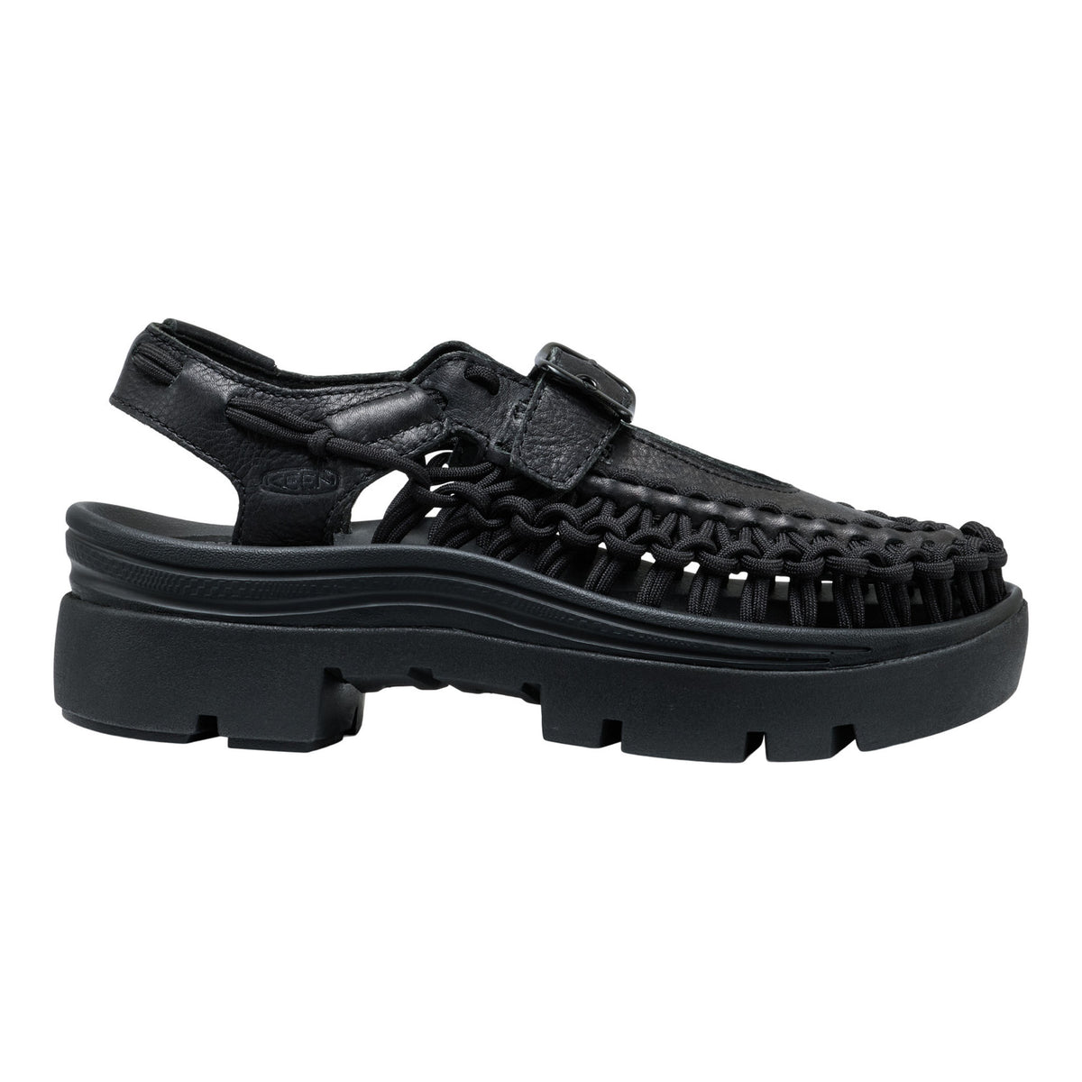 Black sandal with thick sole on a white background