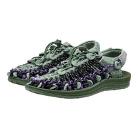 Pair of green and gray sandals with purple accents on a white background