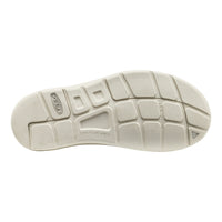 The outsole of a Skechers Contour Arch shoe in a light cream or off-white color, showing the tread pattern and embossed brand markings on a solid white background.