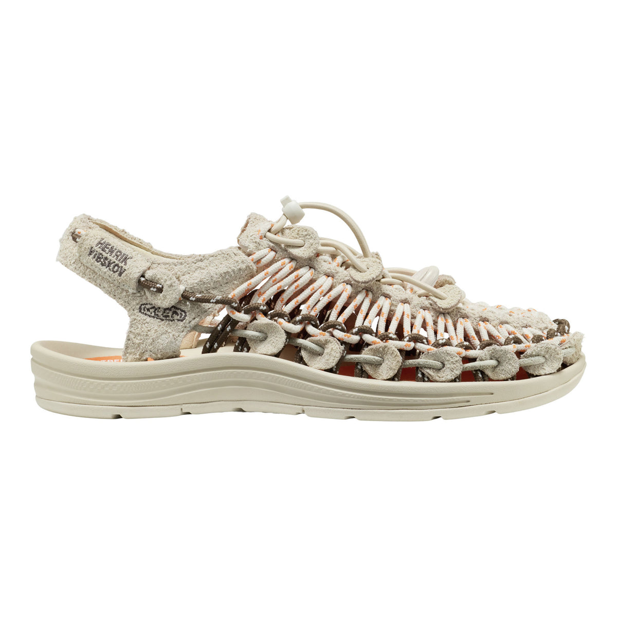 KEEN sandal shown in profile against a plain white background. The sandal features a textured, woven upper made of beige, brown, and white elements, with a matching beige sole and heel strap.