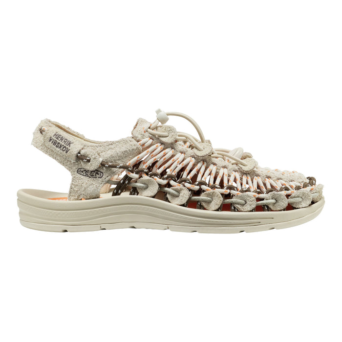 KEEN sandal shown in profile against a plain white background. The sandal features a textured, woven upper made of beige, brown, and white elements, with a matching beige sole and heel strap.