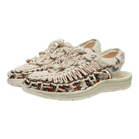 A pair of woven open-toe sandals with a chunky beige sole, featuring a textured knit upper in beige, brown, and orange tones, shown on a plain white background.