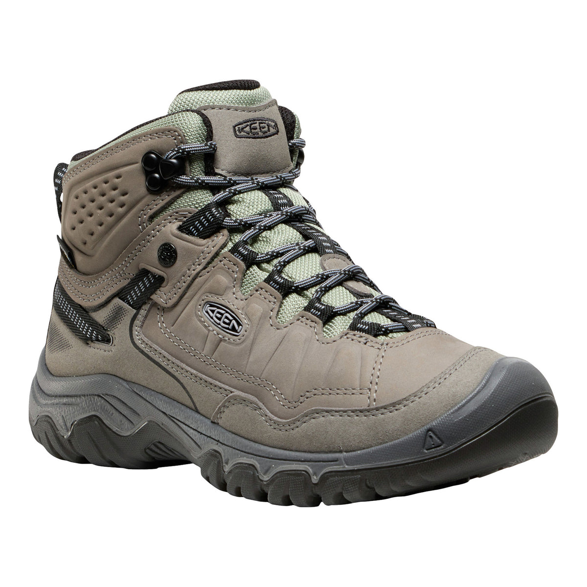 Tan hiking boot with black laces on a white background