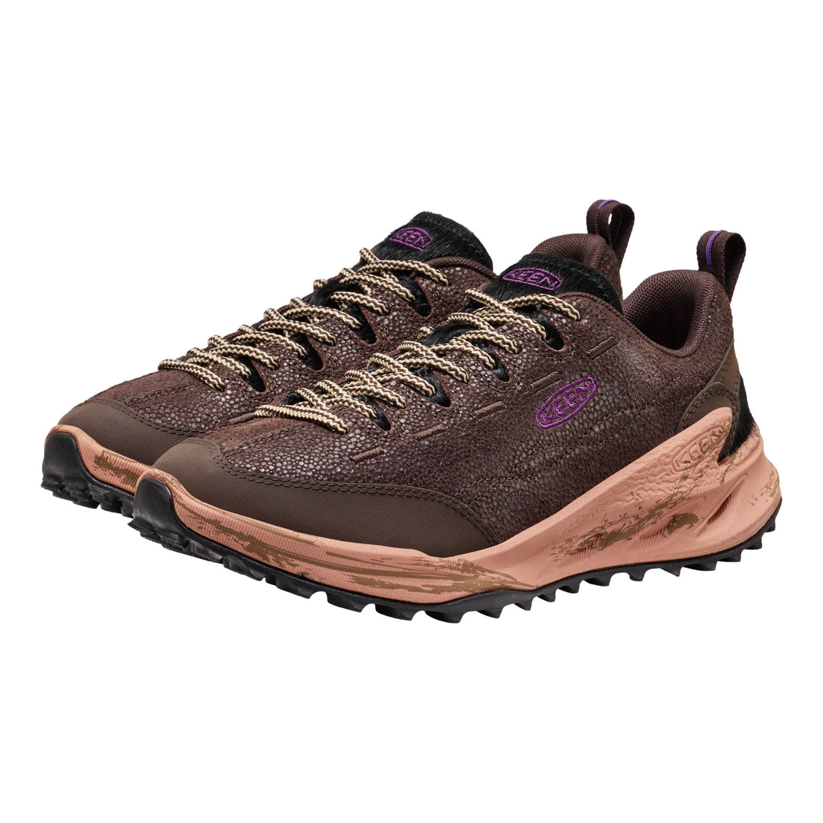 A pair of brown textured Jasper Zionic shoes with beige laces, purple logo accents, and a chunky tan and black sole, shown on a plain white background.