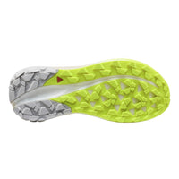 Close-up of a running shoe sole with green tread pattern on a white background