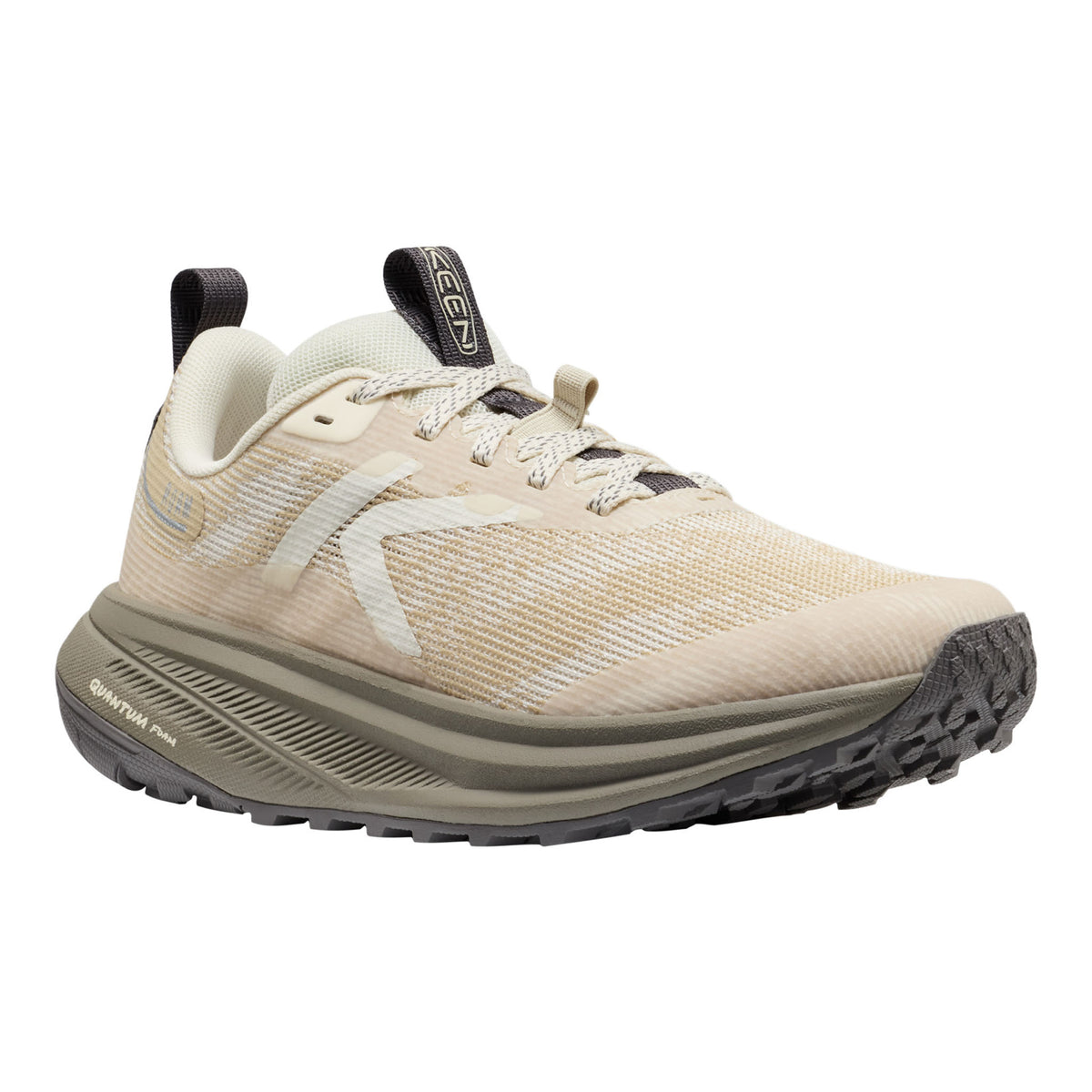 Beige running shoe with black sole on a white background