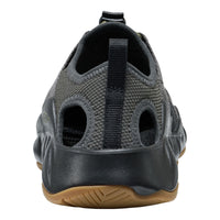 Black mesh shoe with brown sole on a white background