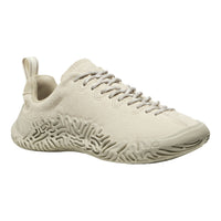 A single low-top sneaker in a uniform light cream or off-white color, featuring a textured knit upper, matching laces, and a sculpted, maze-like sole, shown against a plain white background.