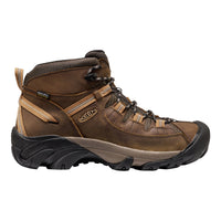Brown hiking boot with black sole on a white background