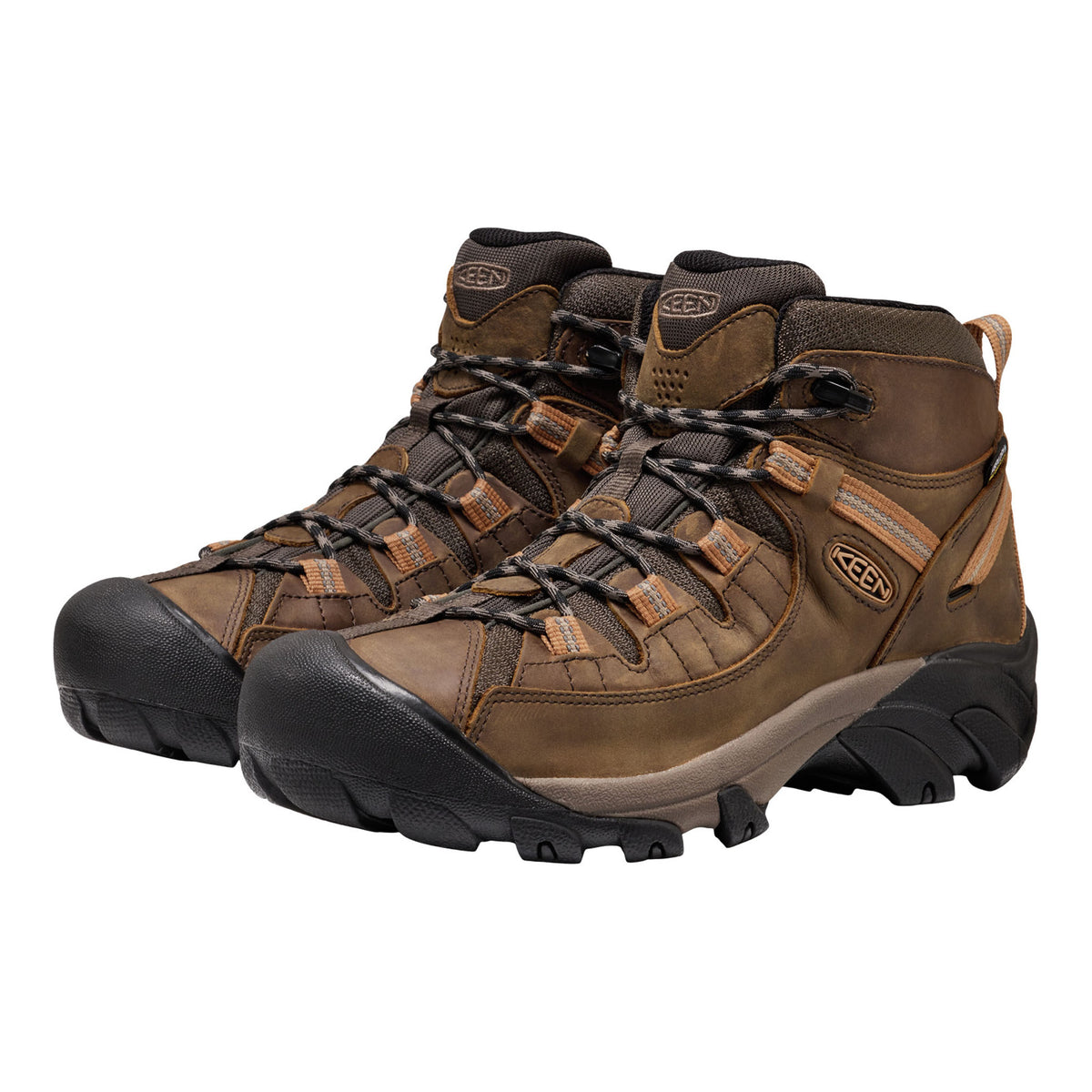 Pair of brown hiking boots with black soles on a white background