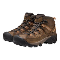Pair of brown hiking boots with black soles on a white background