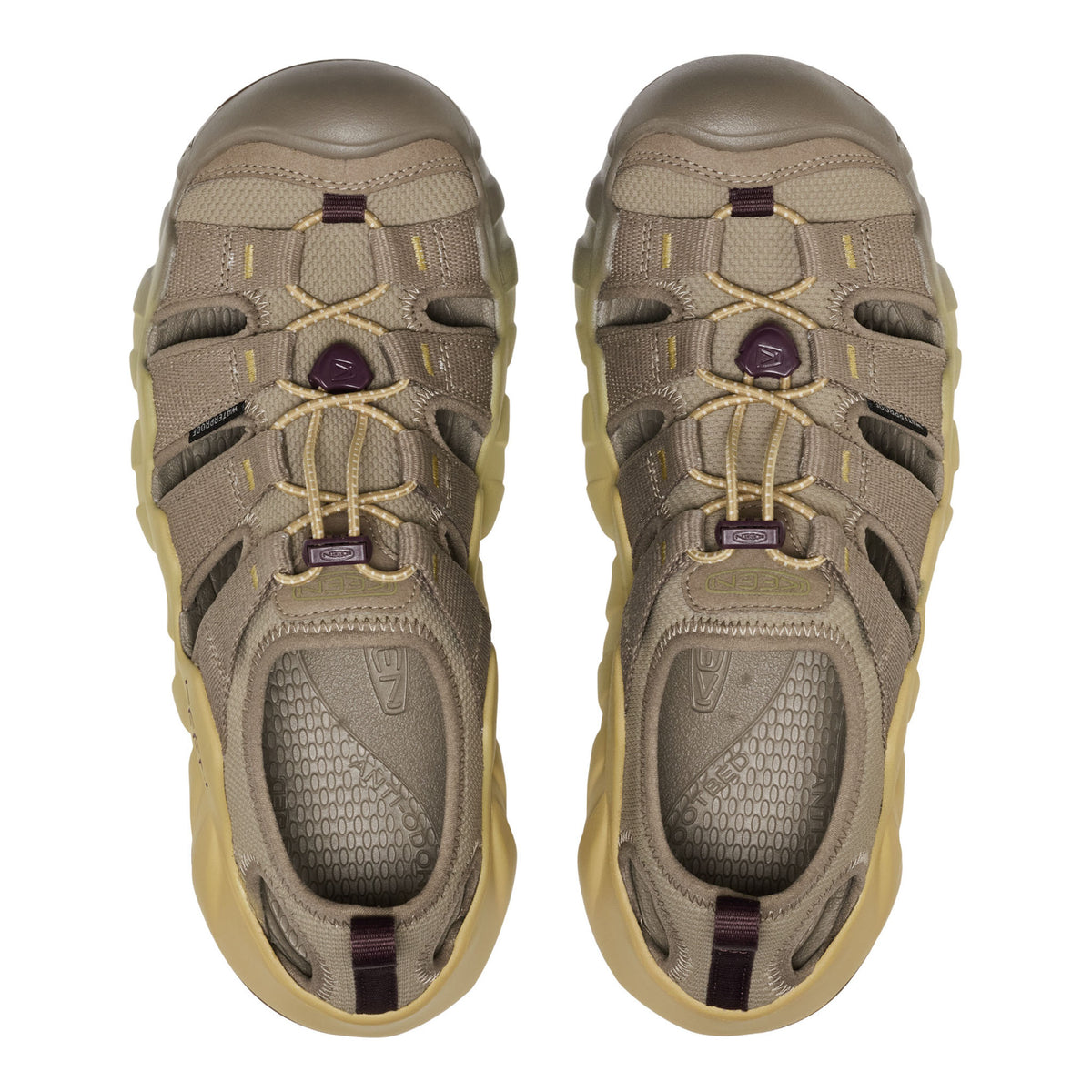 A pair of Keen outdoor water shoes in a muted taupe and khaki colourway with light tan laces and small dark purple accents on the laces and heel pull tabs, shown from a top-down view on a white background.