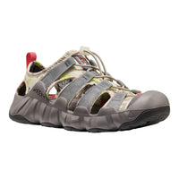 A Keen brand water sport sandal in a gray and beige colorway, featuring adjustable straps, a protective toe cap, and a red pull tab on a white background.