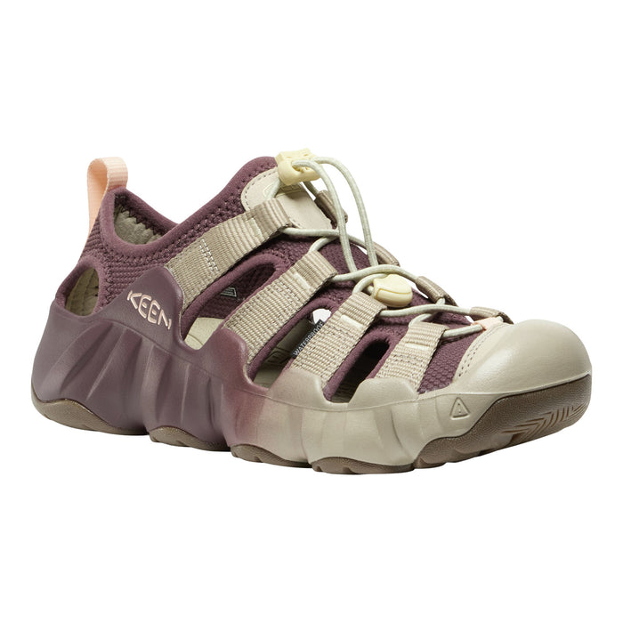 A Keen water shoe in a muted plum purple and beige colorway, featuring adjustable straps, a protective toe cap, and a thick textured sole, shown against a plain white background.