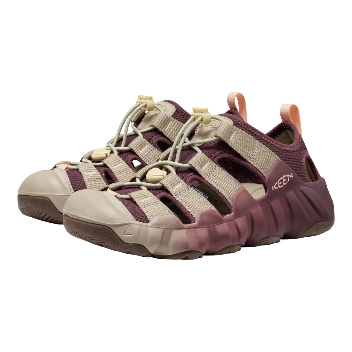 Keen brand outdoor sandal in a colorway of dusty burgundy and beige, featuring adjustable straps and a chunky sole, shown against a plain white background.