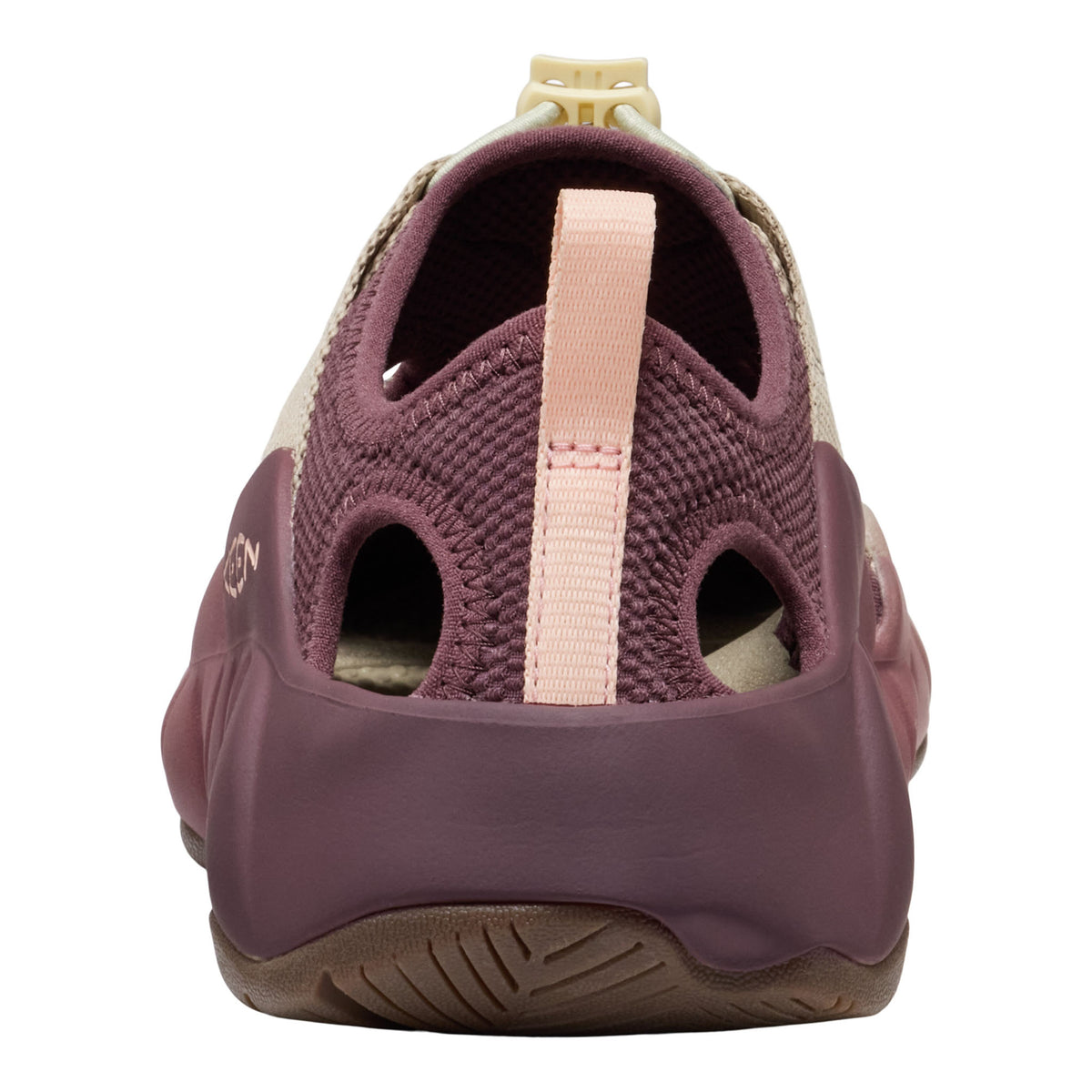 A close-up rear view of a water shoe in dusty purple and light pink, featuring a knit upper, cutout design, and a pull tab.