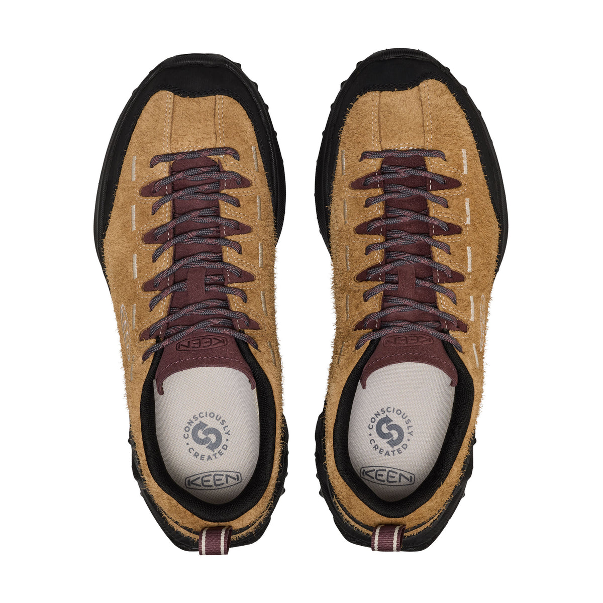 Pair of tan and black shoes with brown laces on a white background