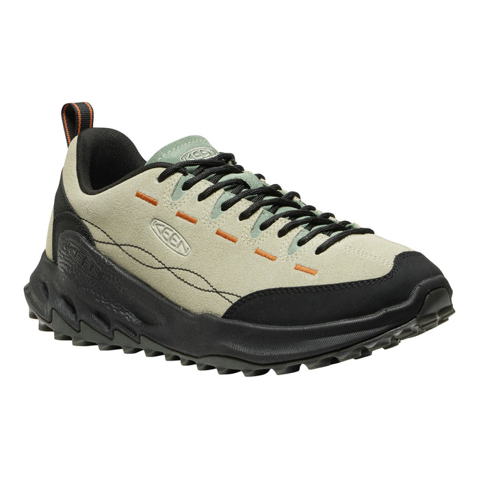 A Keen brand outdoor shoe in light beige suede and black synthetic materials, featuring black laces, orange stitching accents, and a rugged black sole, shown against a plain white background.