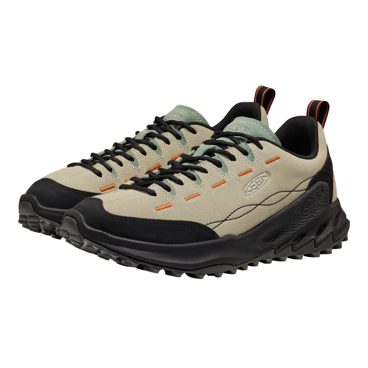 A pair of Keen shoes in beige and black with orange accents, shown on a plain white background.