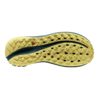 The textured outsole of a trail running shoe, featuring a pale yellow tread with a dark teal central channel and a small red logo accent.