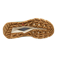 A top-down view of a rugged tan and beige outdoor shoe sole with a textured tread pattern and a visible Keen logo.