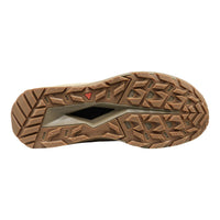 A top-down view of a brown rugged shoe sole with deep tread patterns and a small red triangular logo, shown on a plain white background.