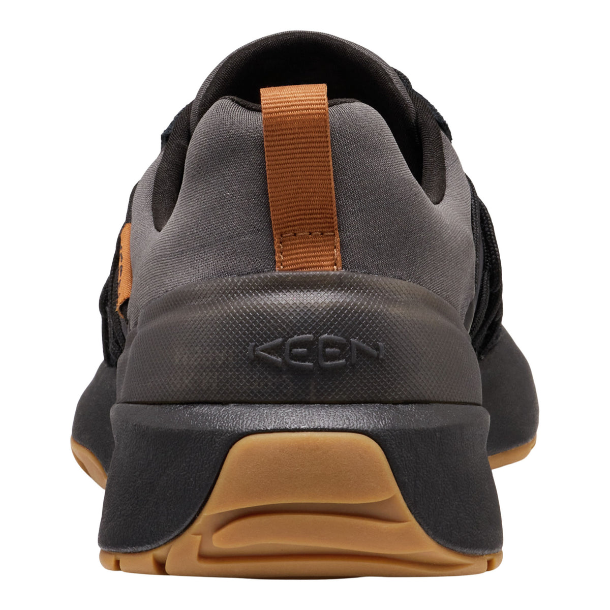 A close-up rear view of a K-SAN athletic shoe in dark gray and black with a tan pull tab and gum-colored outsole.