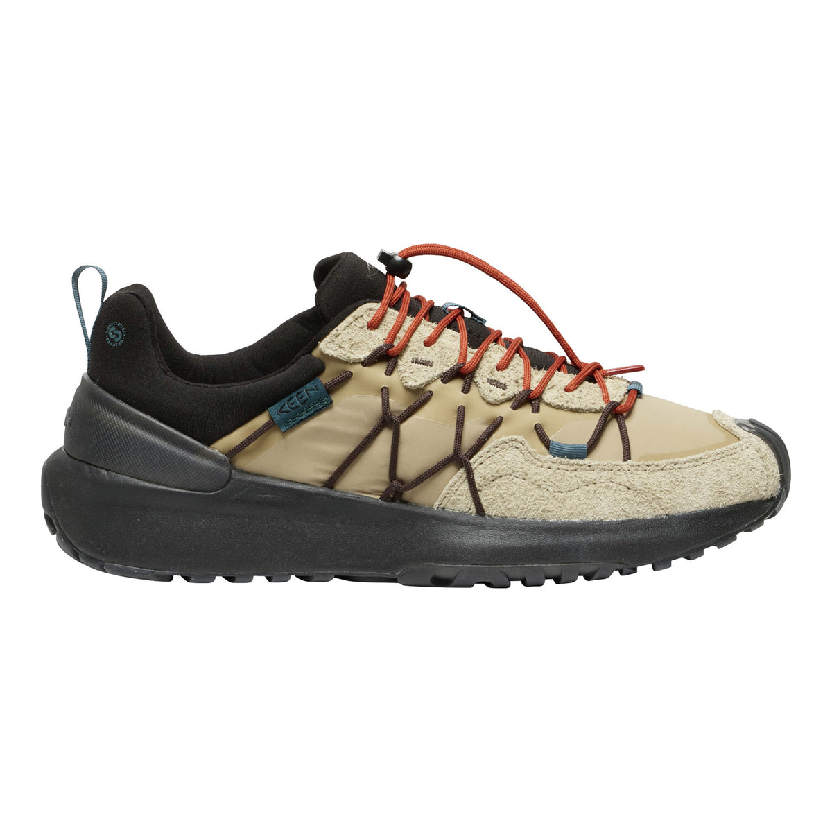 A low-top outdoor shoe shown in profile against a plain white background. The upper is primarily beige with black overlays, dark brown lace-like accents, and bright orange laces.
