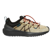 A low-top outdoor shoe shown in profile against a plain white background. The upper is primarily beige with black overlays, dark brown lace-like accents, and bright orange laces.