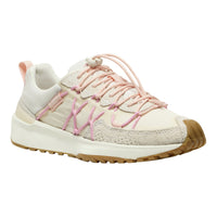 A low-top sneaker in off-white and light pink, featuring textured mesh panels, pink decorative laces, and a gum brown outsole, shown against a plain white background.