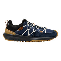 A single low-top outdoor shoe shown in profile against a plain white background. The upper is primarily navy blue with a black collar and tongue area, white crisscross laces, tan/gum outsole and heel accent, and a small brown brand patch.