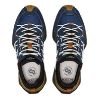 A pair of Keen hiking shoes shown from a top-down view, featuring a navy blue suede and mesh upper with white laces, tan leather accents, and a black sole.