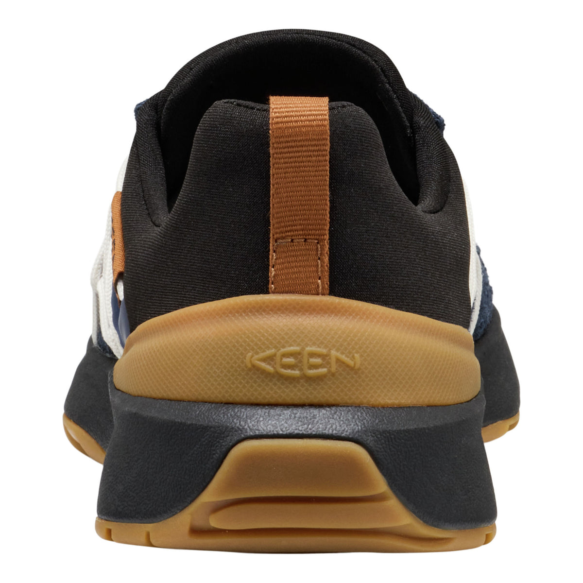 Close-up rear view of a KEEN sneaker in black, brown, and white, showing the black fabric upper, a brown pull tab, and a tan midsole with the KEEN logo.