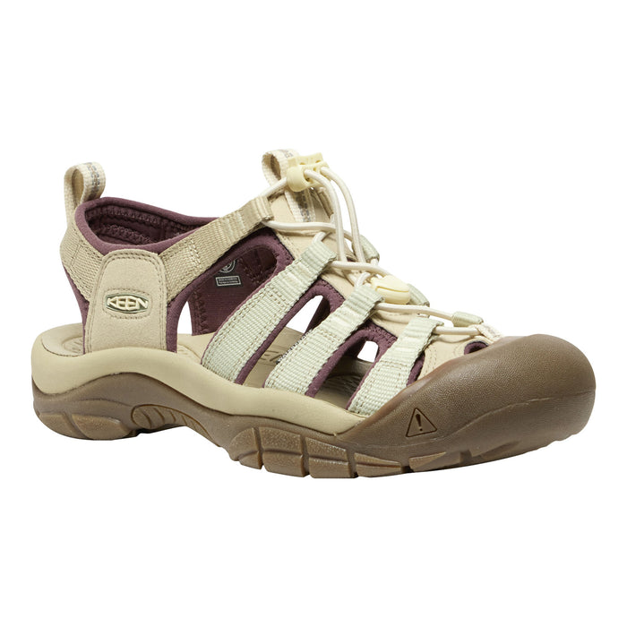 A Keen brand low-top hiking sandal in beige and brown with dark purple accents on the straps and lining, shown from a side profile on a white background.