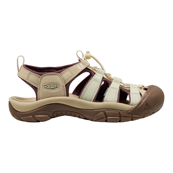 A Keen brand women's sandal in beige and brown, featuring cream-colored laces and a dark brown protective toe cap, shown from a side profile on a white background.