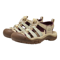Keen brand women's hiking sandals in beige and brown with dark burgundy lining, shown against a plain white background.