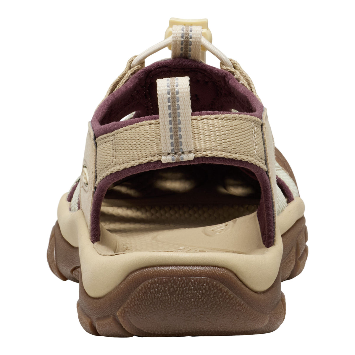 A close-up rear view of a casual lace-up sandal, featuring a beige woven upper, a dark plum purple lining, and a brown textured sole, shown against a plain white background.