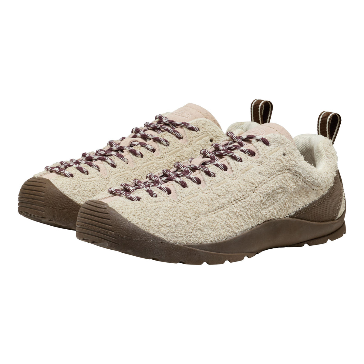 A pair of low-top slip-on shoes with a textured cream knit upper, brown laces, and brown soles, shown against a plain white background.