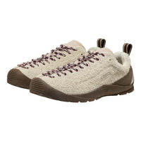 A pair of low-top slip-on shoes with a textured cream knit upper, brown laces, and brown soles, shown against a plain white background.