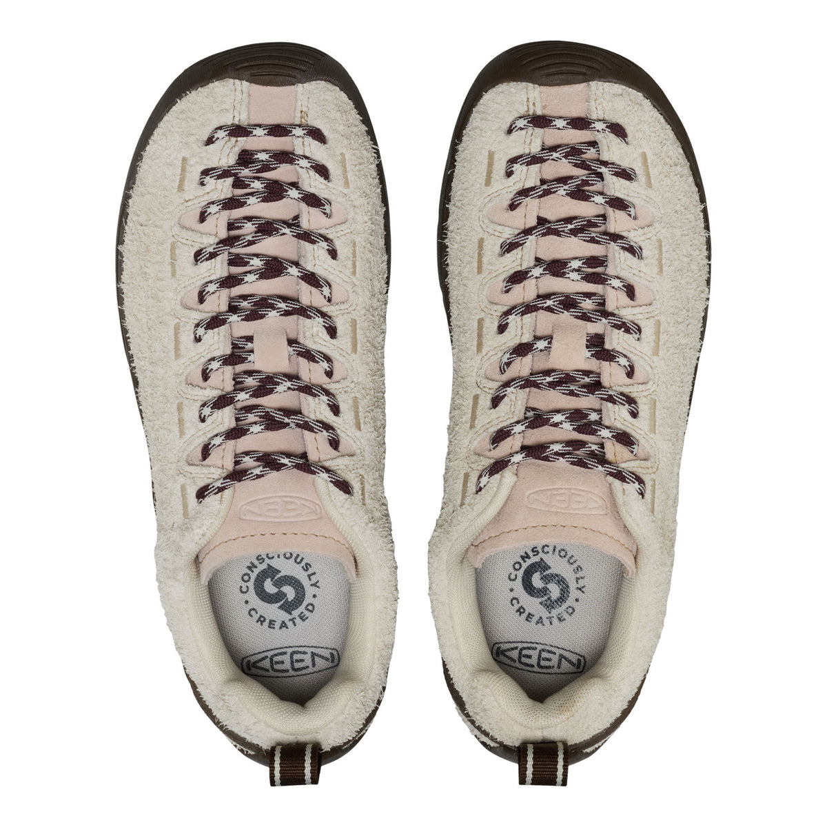 A pair of Keen boots shown from a top-down view, featuring a cream sherpa-lined suede upper, beige laces with dark speckles, and a dark brown rubber toe cap.