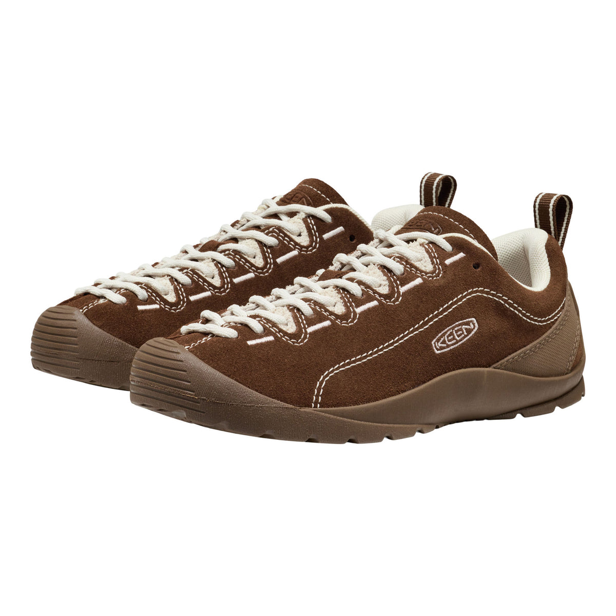 A pair of brown suede Keen sneakers with white laces and white contrast stitching, shown from a three-quarters angle on a white background.