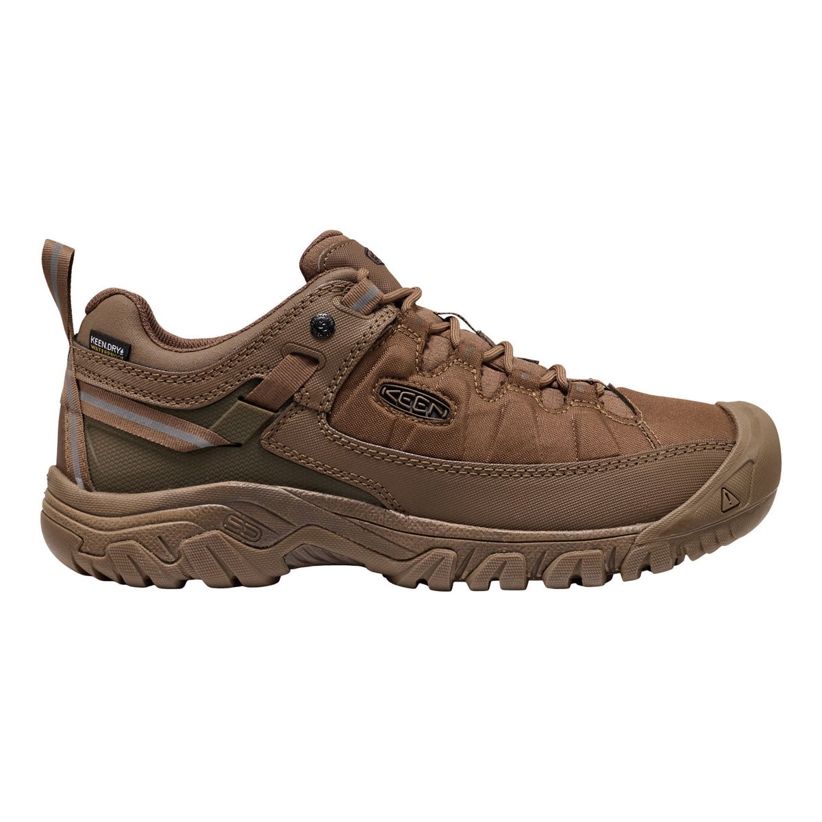 A brown Keen hiking shoe with a rugged sole, lace-up front, and a small reflective stripe on the side, shown against a plain white background.